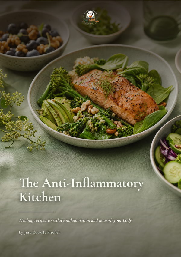 A styled food photography cover for 'The Anti-Inflammatory Kitchen' by Just Cook It kitchen, featuring a plated salmon fillet on a bed of greens, broccoli, and avocado, with other bowls of salad and blueberries in the background on a muted sage green surface.