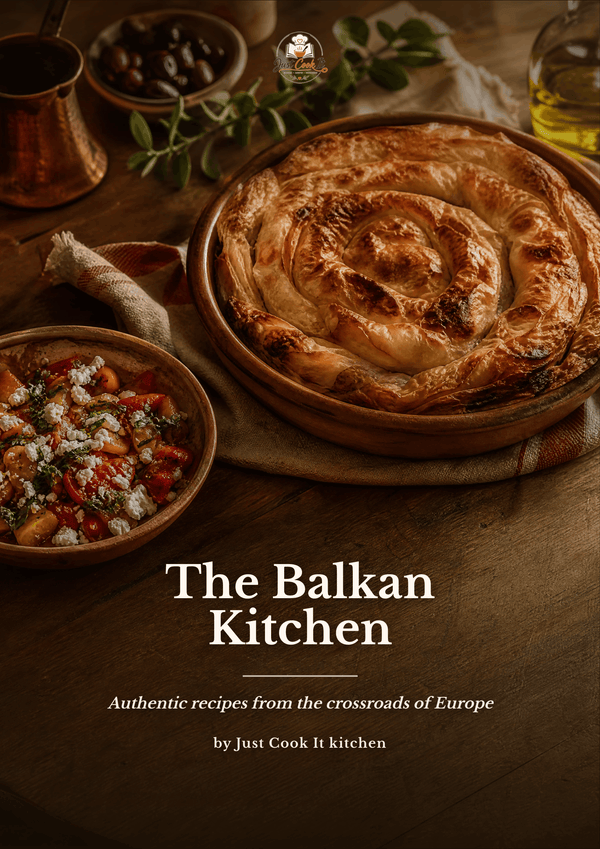 A rustic food photography cover for 'The Balkan Kitchen' by Just Cook It kitchen, featuring a golden-brown baked pastry in a round wooden dish on a dark wooden table, surrounded by bowls of food and herbs.